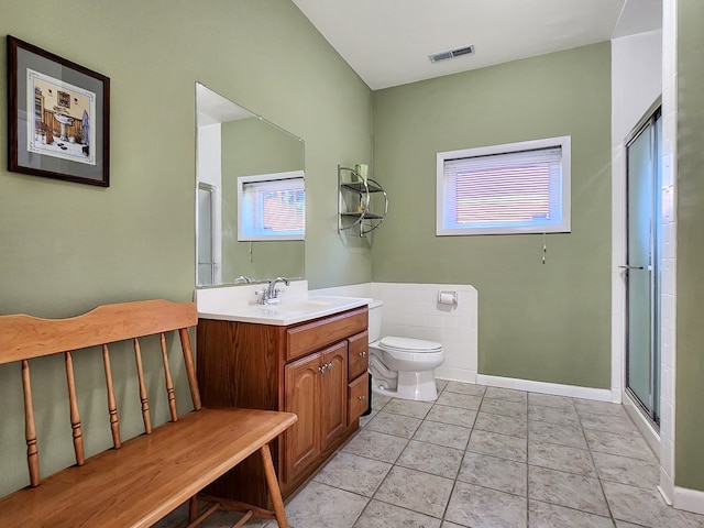 full bath with a shower with door, visible vents, toilet, vanity, and tile patterned flooring