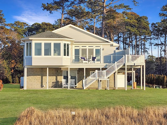 back of house featuring stairs, a deck, and a yard