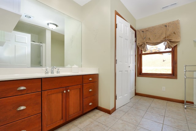 full bath featuring baseboards, visible vents, tile patterned floors, vanity, and a shower stall