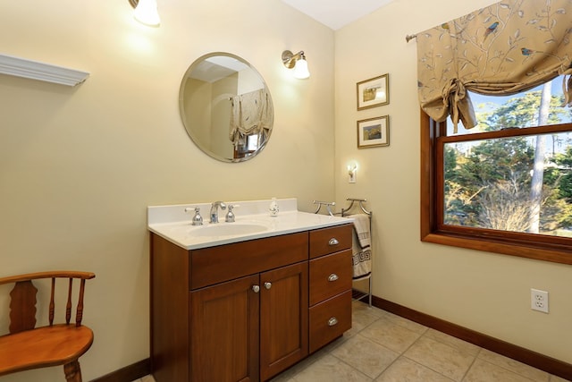 bathroom with tile patterned flooring, vanity, and baseboards