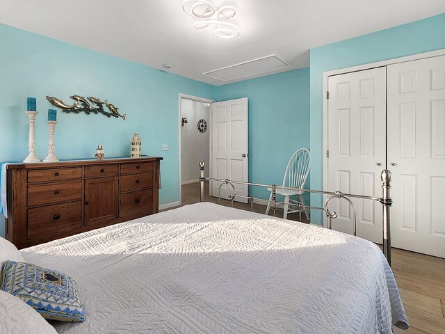 bedroom featuring a closet, baseboards, and wood finished floors