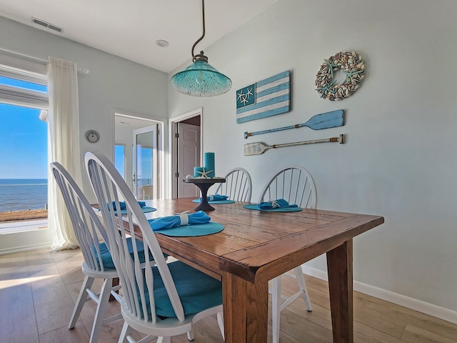 dining space with visible vents, plenty of natural light, and light wood-style flooring