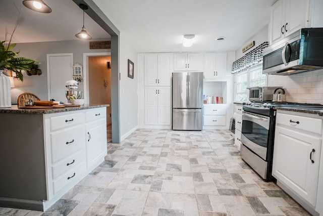 8045 Hickman Farm Ln, Wallops Island, VA 23337 - kitchen featuring decorative backsplash, white cabinets, baseboards, and stainless steel appliances