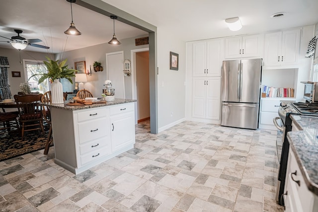 8045 Hickman Farm Ln, Wallops Island, VA 23337 - kitchen with ceiling fan, visible vents, appliances with stainless steel finishes, stone counters, and white cabinetry