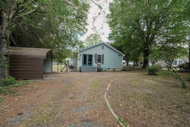 8045 Hickman Farm Ln, Wallops Island, VA 23337 - back of house featuring a detached carport and entry steps