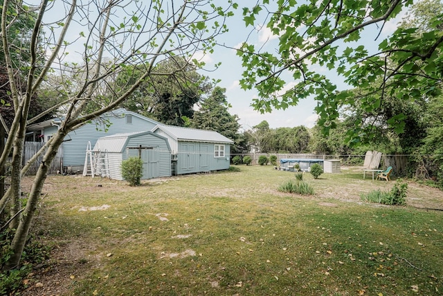 8045 Hickman Farm Ln, Wallops Island, VA 23337 - view of yard featuring a storage shed, a fenced in pool, an outbuilding, and a fenced backyard