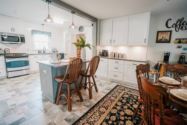 8045 Hickman Farm Ln, Wallops Island, VA 23337 - kitchen with stainless steel appliances, light stone countertops, white cabinetry, and tasteful backsplash