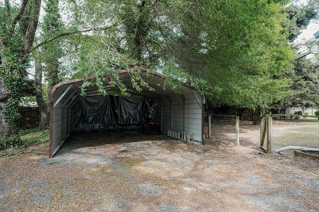 8045 Hickman Farm Ln, Wallops Island, VA 23337 - view of outbuilding featuring fence and a detached carport