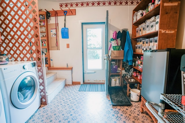 8045 Hickman Farm Ln, Wallops Island, VA 23337 - clothes washing area featuring washer / dryer, tile patterned floors, baseboards, and laundry area