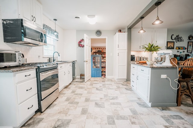 8045 Hickman Farm Ln, Wallops Island, VA 23337 - kitchen featuring stone counters, appliances with stainless steel finishes, tasteful backsplash, and a sink
