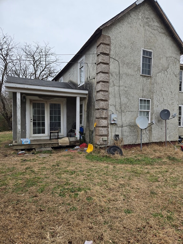 back of property with a lawn