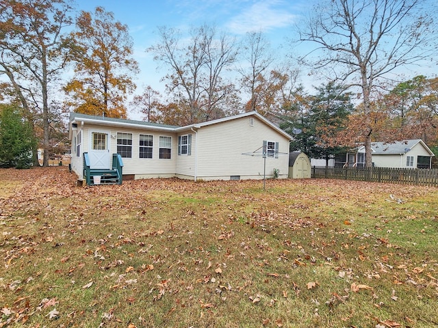 back of house featuring a yard