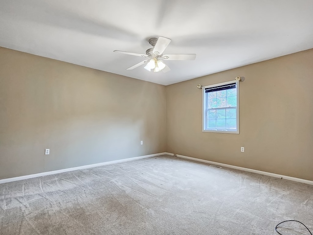 empty room with ceiling fan and light carpet