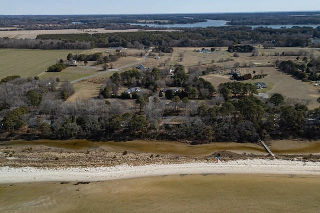 birds eye view of property with a water view, a beach view, and a rural view