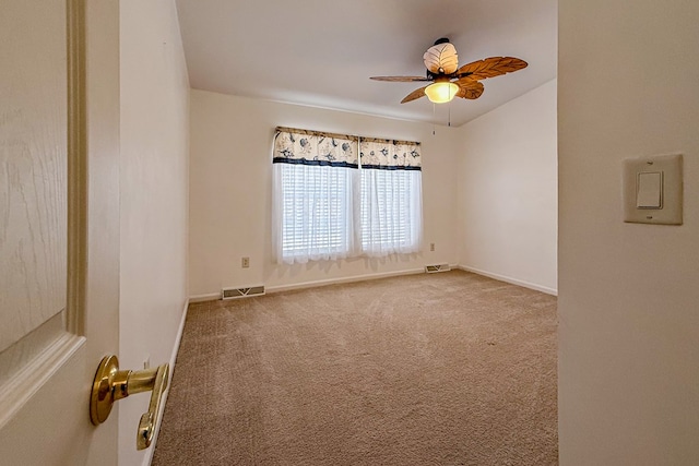 empty room with ceiling fan, carpet, visible vents, and baseboards