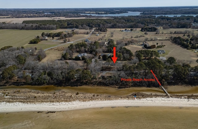 birds eye view of property with a water view, a beach view, and a rural view