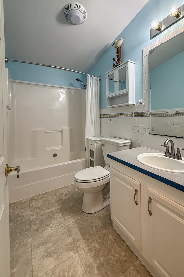 bathroom with tile walls, visible vents, toilet, shower / bath combo, and vanity