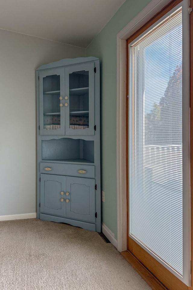 interior space featuring carpet floors and baseboards