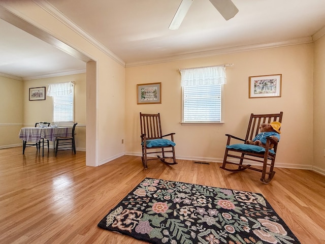 21382 Southside Rd, Onancock, VA 23417 - living area featuring wood finished floors, ornamental molding, and a ceiling fan
