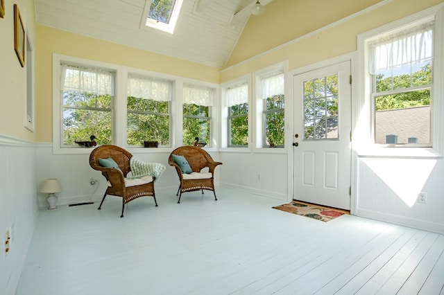 21382 Southside Rd, Onancock, VA 23417 - sunroom featuring a skylight, wood finished floors, healthy amount of natural light, vaulted ceiling, and a wainscoted wall