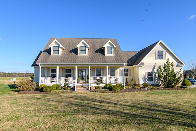 new england style home featuring covered porch and a front lawn