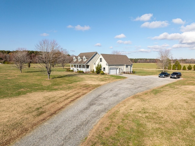 view of front facade featuring covered porch, a garage, and a front lawn