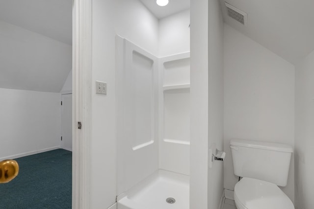 bathroom with toilet, walk in shower, and vaulted ceiling