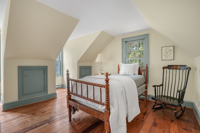 bedroom with hardwood / wood-style flooring, a baseboard radiator, and lofted ceiling