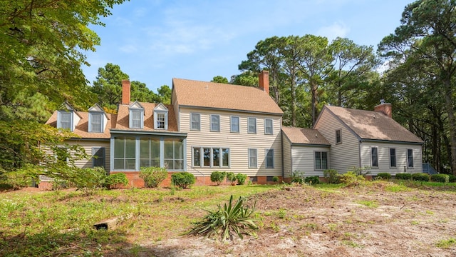 rear view of property featuring a sunroom