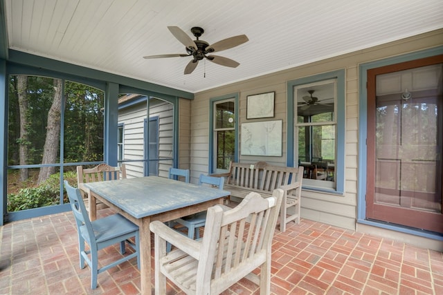 sunroom / solarium featuring ceiling fan