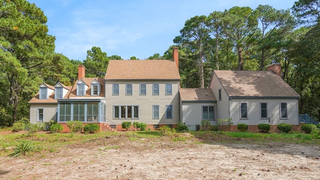 rear view of property featuring a sunroom