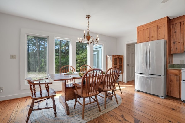 dining room with a notable chandelier and light hardwood / wood-style floors