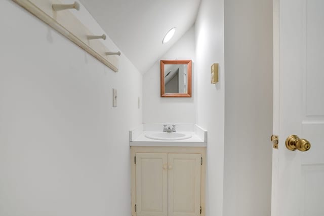 bathroom with vanity and vaulted ceiling