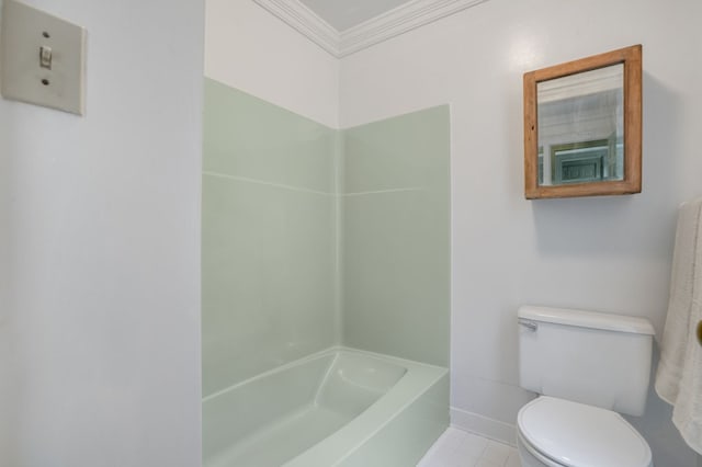 bathroom with tile patterned floors, a tub to relax in, toilet, and ornamental molding