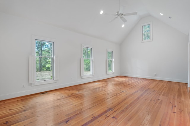 interior space with light wood-type flooring, vaulted ceiling, ceiling fan, and a healthy amount of sunlight