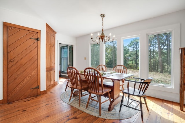 dining room featuring light hardwood / wood-style flooring and an inviting chandelier