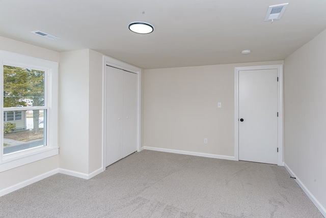 unfurnished bedroom featuring carpet floors and a closet