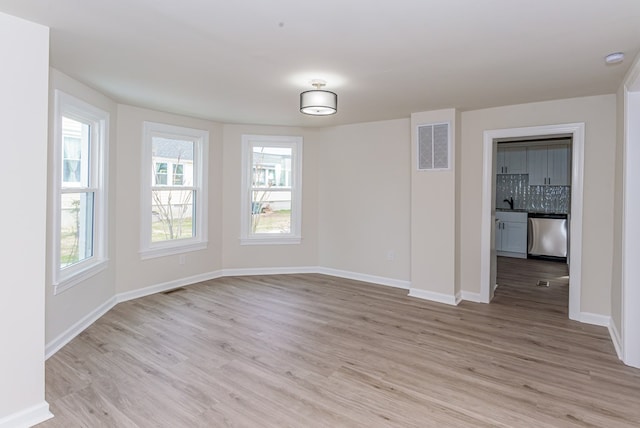 unfurnished room featuring light wood-type flooring