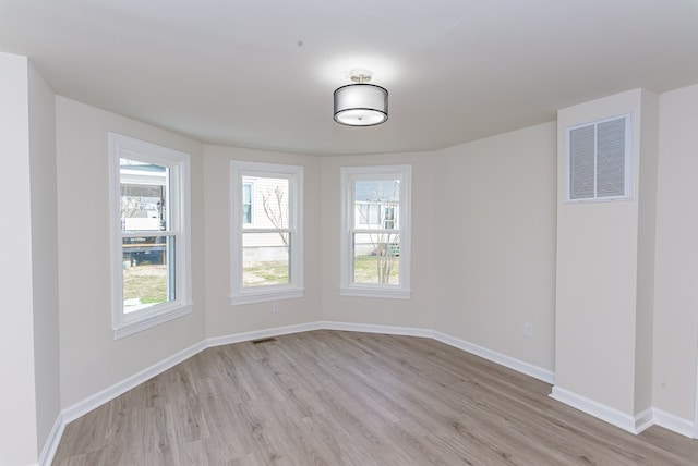 spare room with light hardwood / wood-style flooring