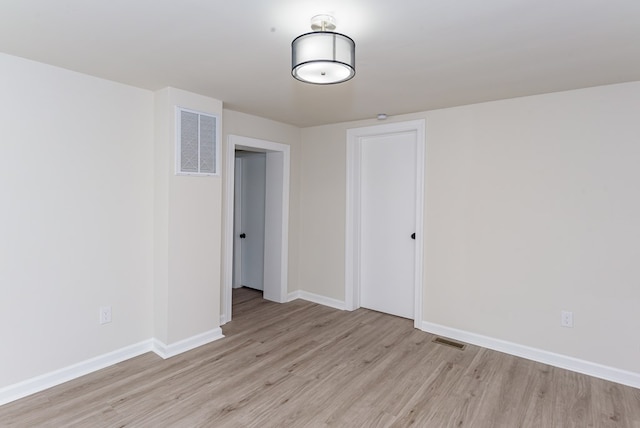 empty room with light hardwood / wood-style floors