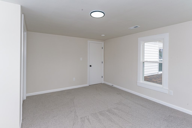 spare room with light carpet