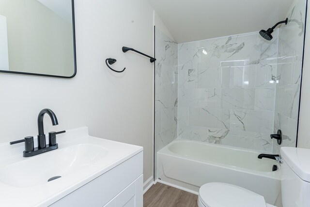 full bathroom with vanity, hardwood / wood-style floors, bathing tub / shower combination, and toilet