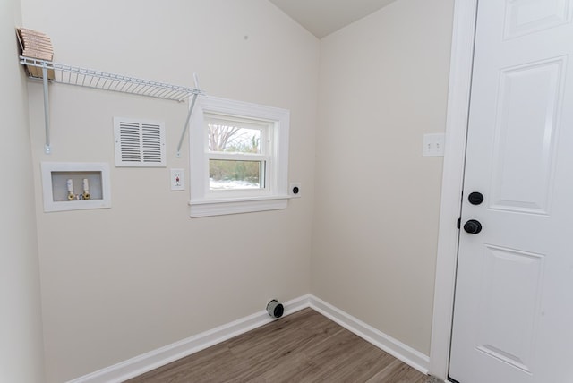 laundry room with wood-type flooring, hookup for an electric dryer, and washer hookup