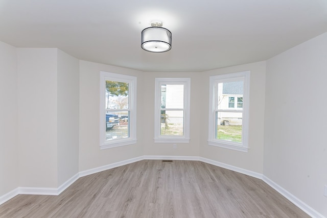 spare room with light hardwood / wood-style floors