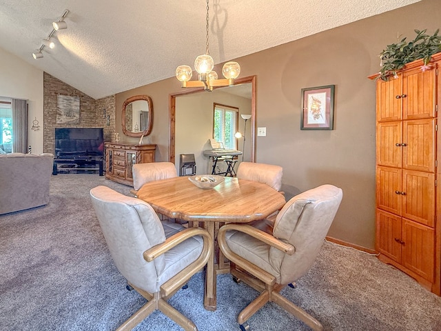 carpeted dining room featuring vaulted ceiling, a textured ceiling, plenty of natural light, and a notable chandelier