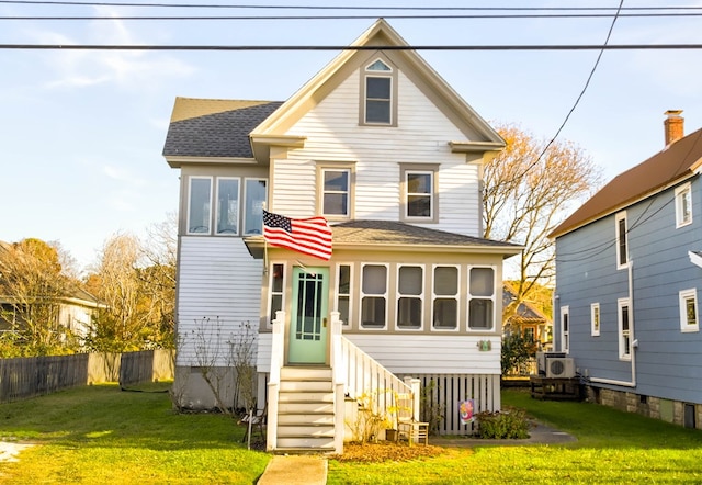 rear view of house with a yard