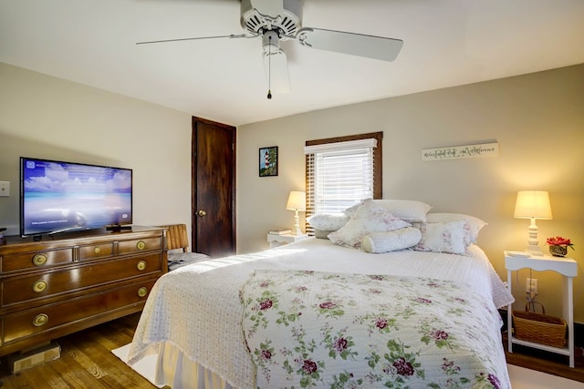 bedroom featuring ceiling fan and dark hardwood / wood-style floors