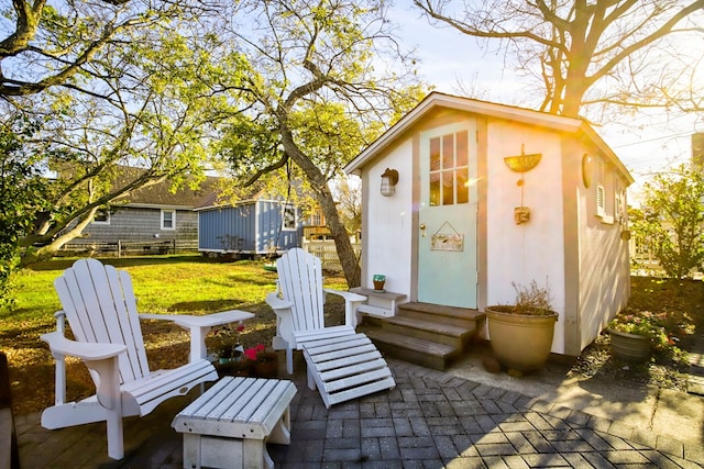 view of patio featuring an outbuilding