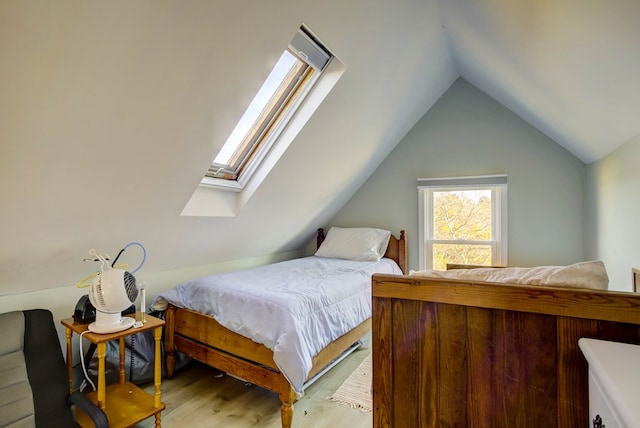 bedroom featuring hardwood / wood-style floors and lofted ceiling