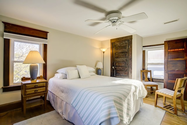 bedroom with hardwood / wood-style flooring and ceiling fan